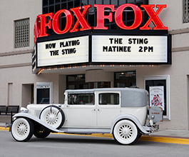 Exterior of the Fox Theater showing the marquee and an antique car